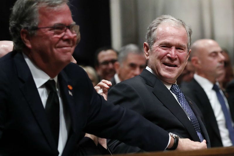 Former President George W. Bush smiles with his brother Jeb Bush at the state funeral for their father, former President George H.W. Bush, at the Washington National Cathedral on December 5, 2018 in Washington, DC.