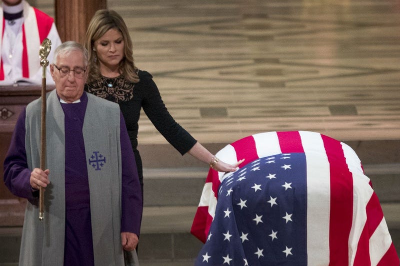 Jenna Bush Hager, the daughter of former President George Bush, touches the casket of former President George H.W. Bush after speaking at his State Funeral at the National Cathedral, December 5, 2018 in Washington, DC.