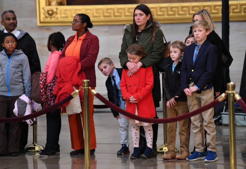 Visitors to the Capitol Rotunda pay respects to President George H.W. Bush as he lies in state at the U.S. Capitol Rotunda.
