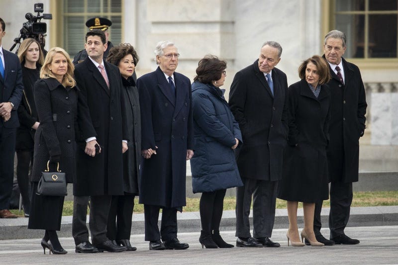 Janna Ryan, Paul Ryan, Elaine Chao, Mitch McConnell, Iris Weinshall, Chuck Schumer, Nancy Pelosi and Paul Pelosi await the departure of the flag-draped casket of the late former President George H.W. Bush at the U.S. Capitol, December 5, 2018.