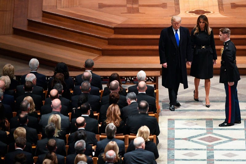 President Donald Trump and first lady Melanie Trump arrive as former President George H.W. Bush is honored with a state funeral at the Washington National Cathedral.