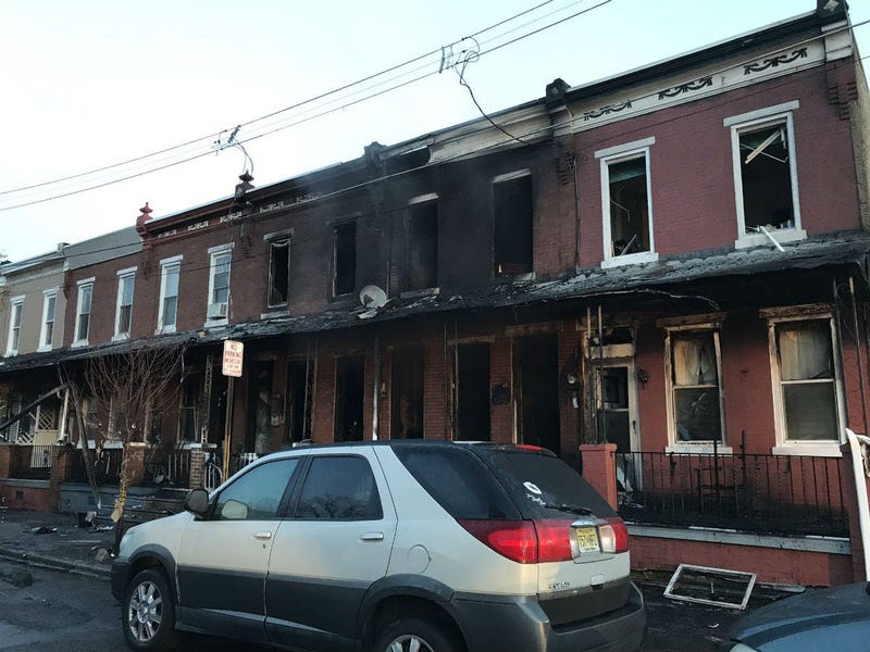 Eight people, including three kids, a police officer and a firefighter, were hurt when fire spread to several rowhomes in Camden early Thursday morning.