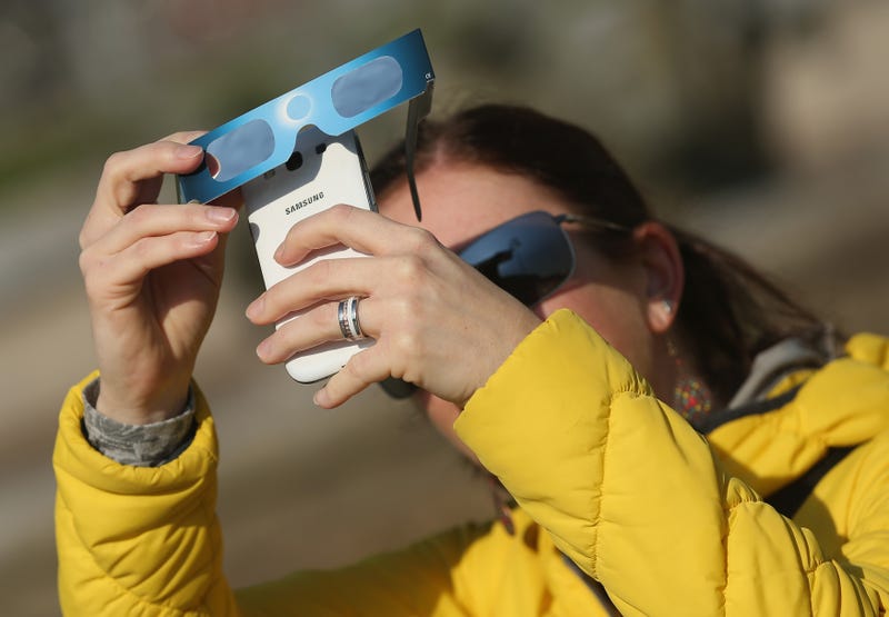 Eclipse-viewing glasses over a phone