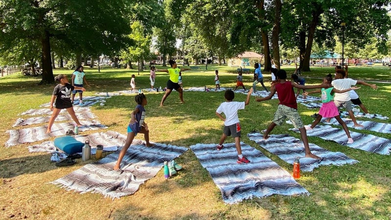 Children are instructed in yoga at Camp Excellence in Malcolm X Park in West Philadelphia.
