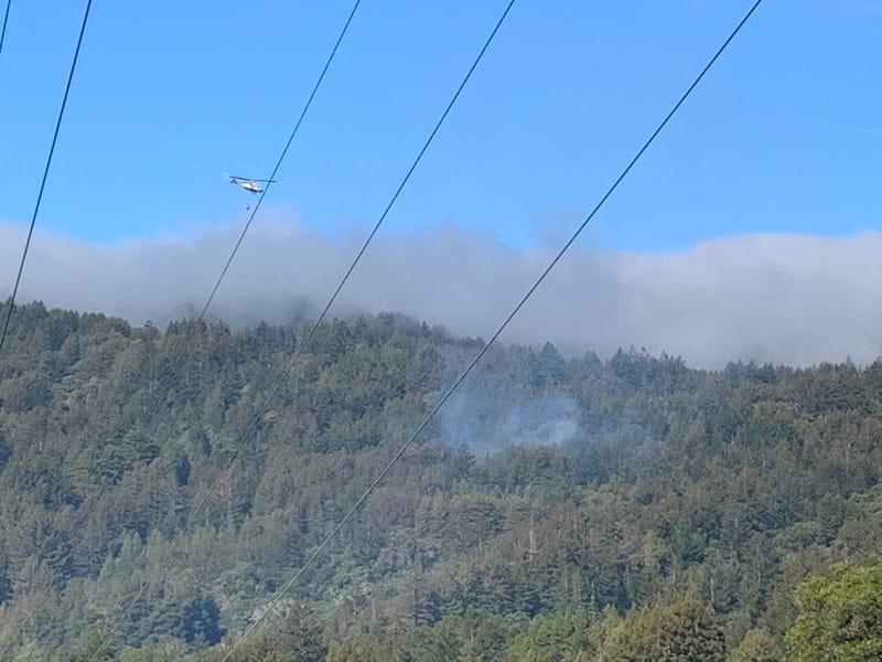CAL FIRE helicopter drops water on the Canada Fire burning in Santa Cruz Mountains, May 14, 2021