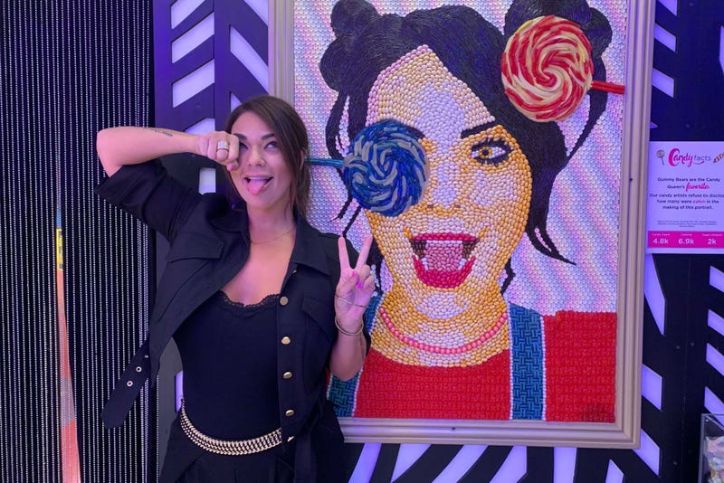 Co-founder Jackie Sorkin stands next to her own candy portrait.
