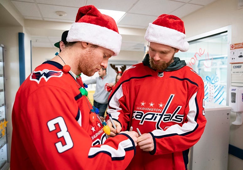 Nick Jensen signs an autograph at MedStar Georgetown University Hospital.