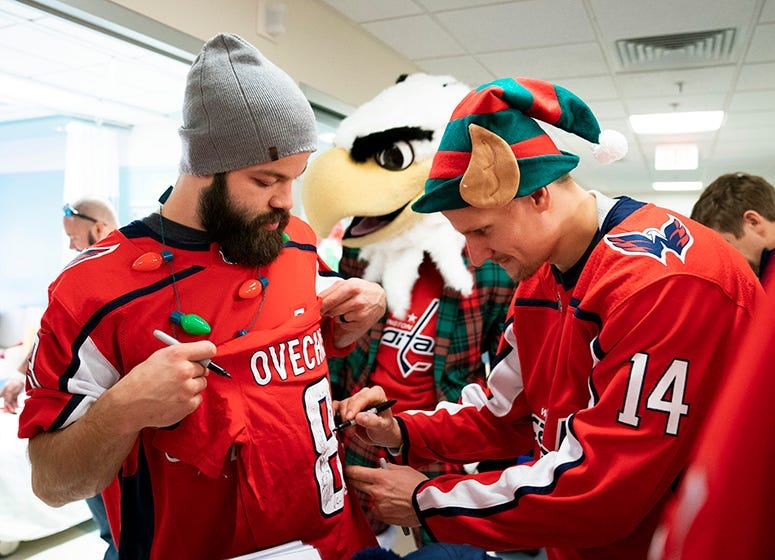 Richard Panik signs an Alex Ovechkin jersey.