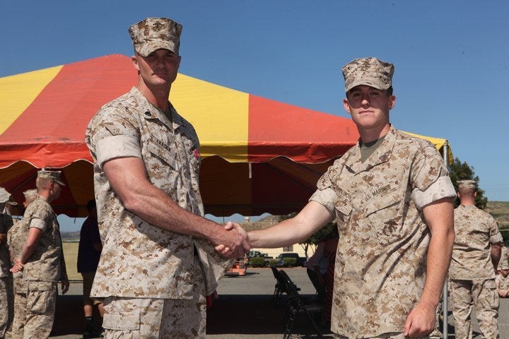 Captain James Ferguson presents Sgt. Josh Frasier with the Bronze Star Medal with Combat V at Camp Pendleton