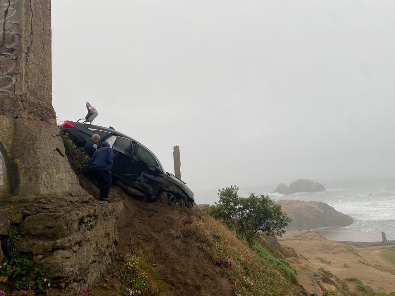 The car dove headfirst off the cliff and fell 40 feet.