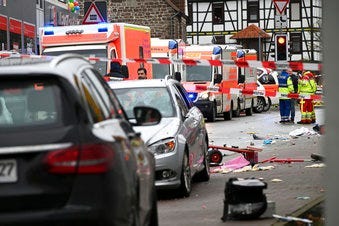 Emergency cars stand next to the scene of the accident with a car that is said to have crashed into a carnival parade in Volkmarsen, central Germany, Monday, Feb. 24, 2020. (Uwe Zucchi/dpa via AP)