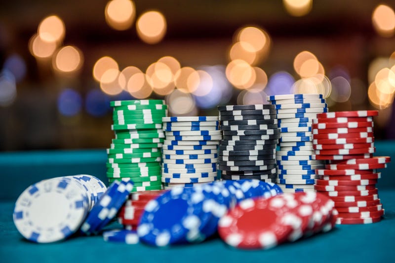 Colorful casino chips on table close up