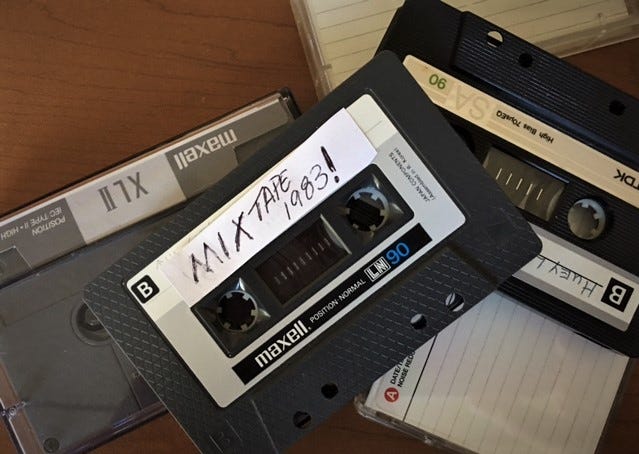 pile of cassette tapes one says MixTape 1983