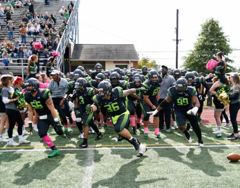 Delaware Valley University football team running out to the field. 