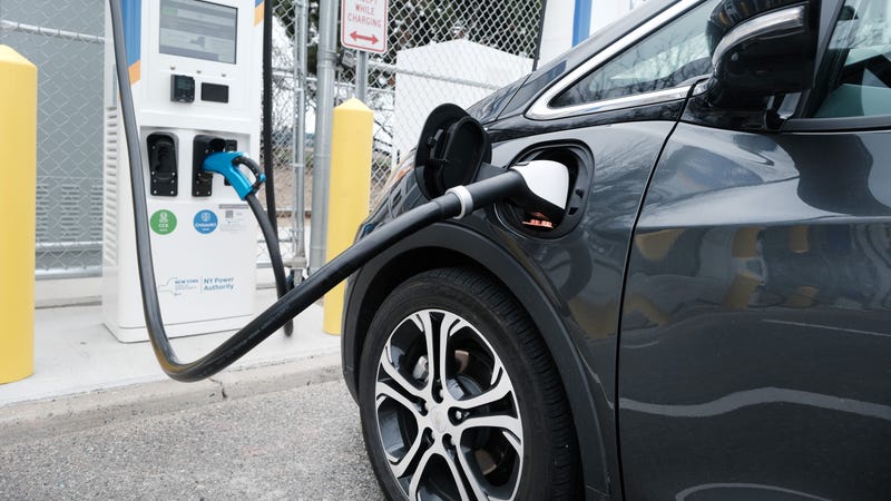 A driver uses a fast-charging station for electric in the cell phone lot at John F. Kennedy (JFK) airport on April 02, 2021 in New York City.