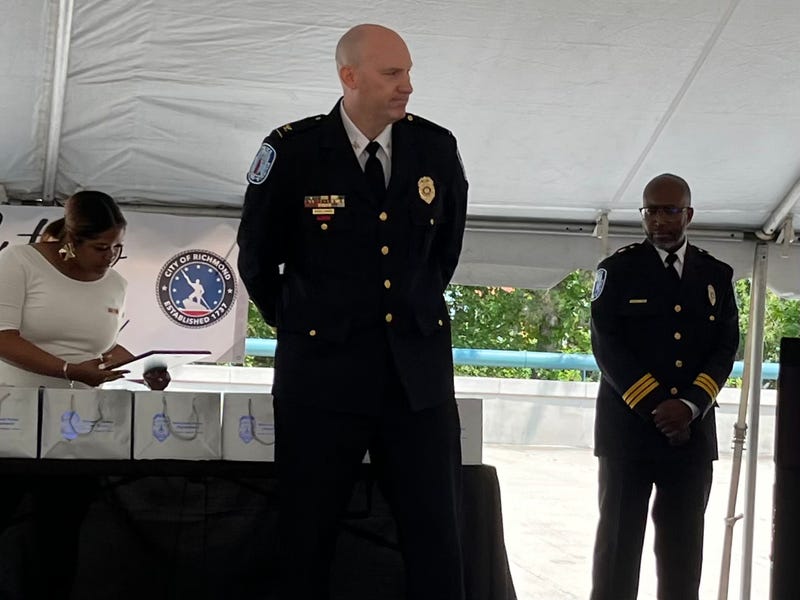 Chief Edwards, on stage, hands behind his back