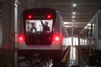 In this March 23, 2020 photo released by Xinhua News Agency, workers prepares a subway train for restoration of public transport in Wuhan, in central China's Hubei province. (Xiao Yijiu/Xinhua via AP)