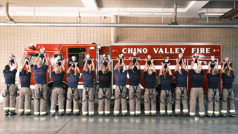 Firefighters in the Chino Valley Fire District welcomed 15 babies into their families in the 12 months leading up to March 3, 2022, when this photo was shared with KNX. The babies ages at the time this photo was taken range between 3 weeks and 12 months old.