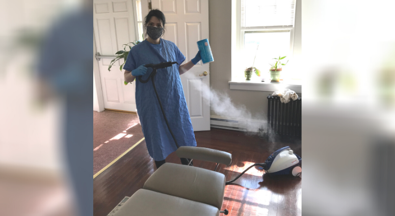 Dr. Sahfi Goldenberg sanitizes chiropractic surfaces in between patients.