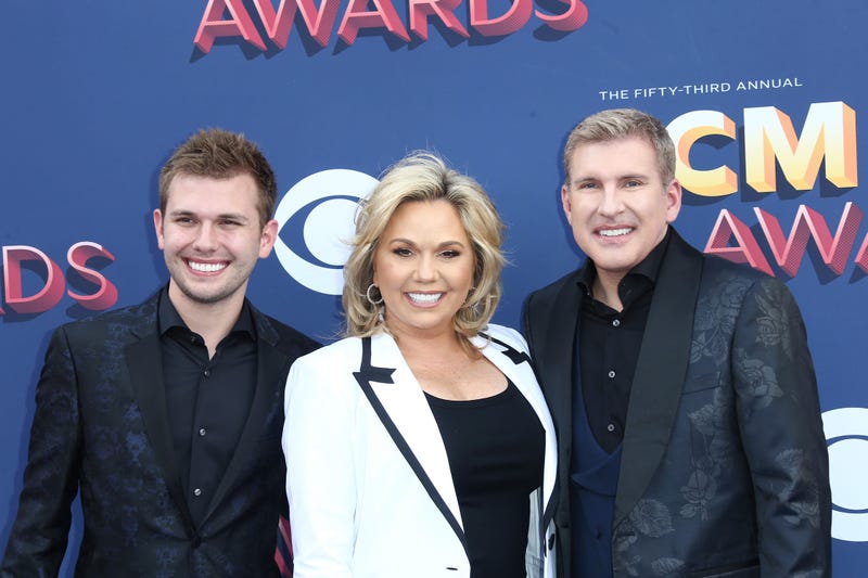 Reality TV stars Todd (far right) and Julie Chrisley (middle) of "Chrisley Knows Best" have been indicted by a federal grand jury in Atlanta