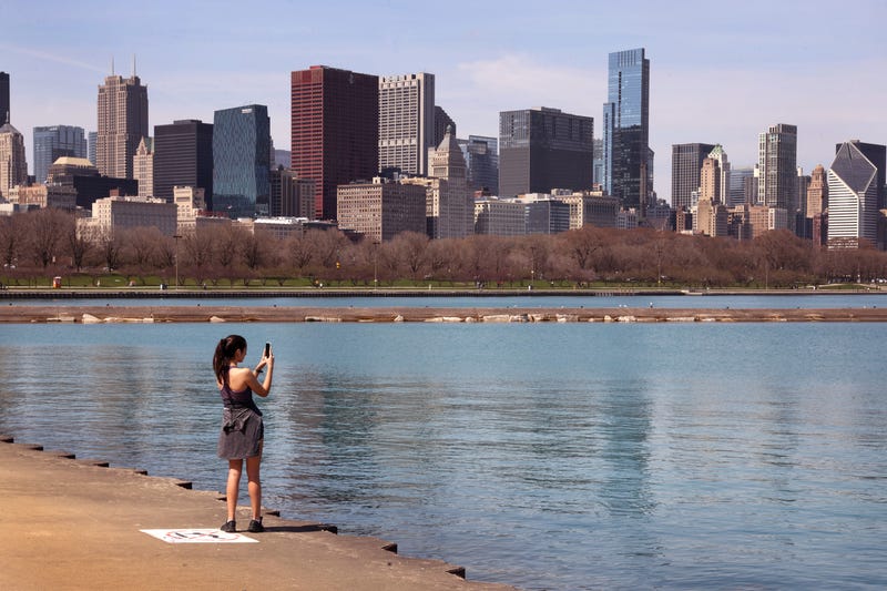 Woman with phone on Chicago's lakefront on sunny day