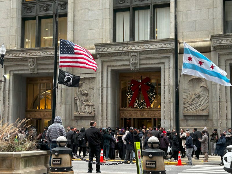 people standing outside City Hall