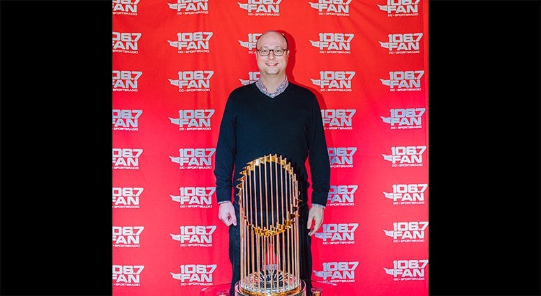 106.7 The Fan Program Director Chris Kinard poses with the World Series trophy