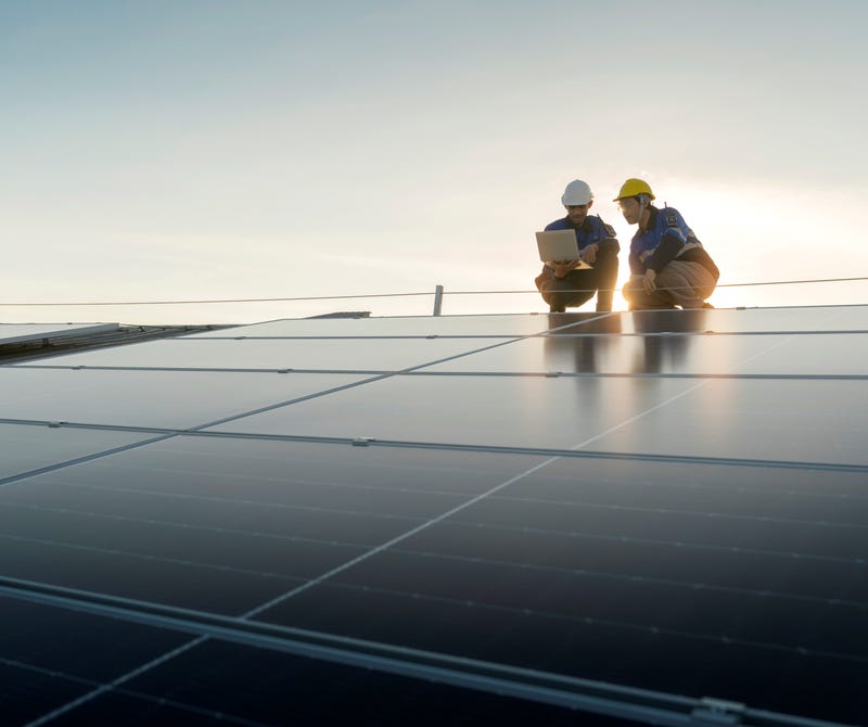 crew amid solar panels