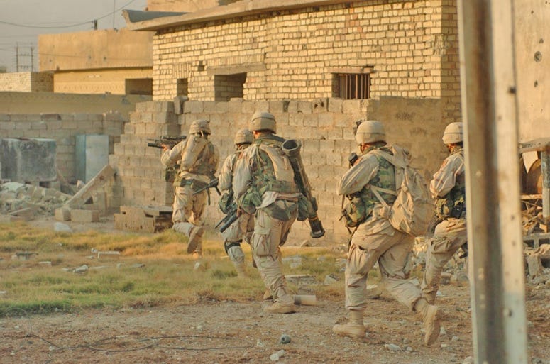 Soldiers from the 1st Infantry Divisions 3rd Brigade Reconnaissance Troop clear houses in Fallujah during Operation Al-Fajr 