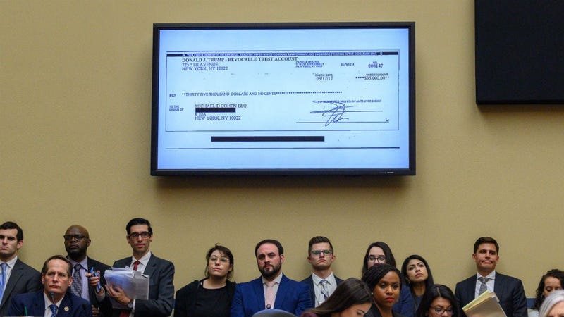 A copy of a check paid to Michael Cohen by President Trump's trust is displayed as Michael Cohen, former lawyer for President Donald Trump, testifies before the House Oversight and Reform Committee on Capitol Hill in Washington, D.C., on February 27, 2019