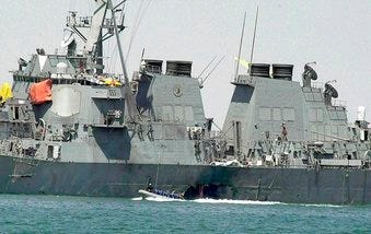 FILE - In this Oct. 15, 2000 file photo, experts in a speed boat examine the damaged hull of the USS Cole at the Yemeni port of Aden after an al-Qaida attack that killed 17 sailors. (AP Photo/Dimitri Messinis, File)