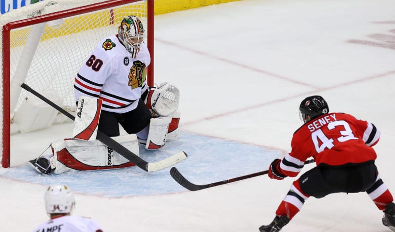 Devils winger Brett Seney (43) scores a goal on Blackhawks goaltender Collin Delia (60).