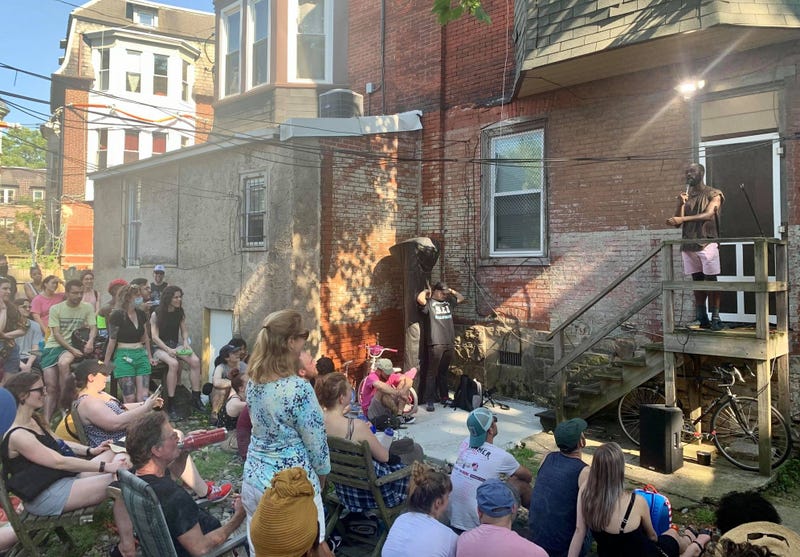 Comedian Momoh Pujeh performs a back porch stand-up set for a Porchfest crowd.