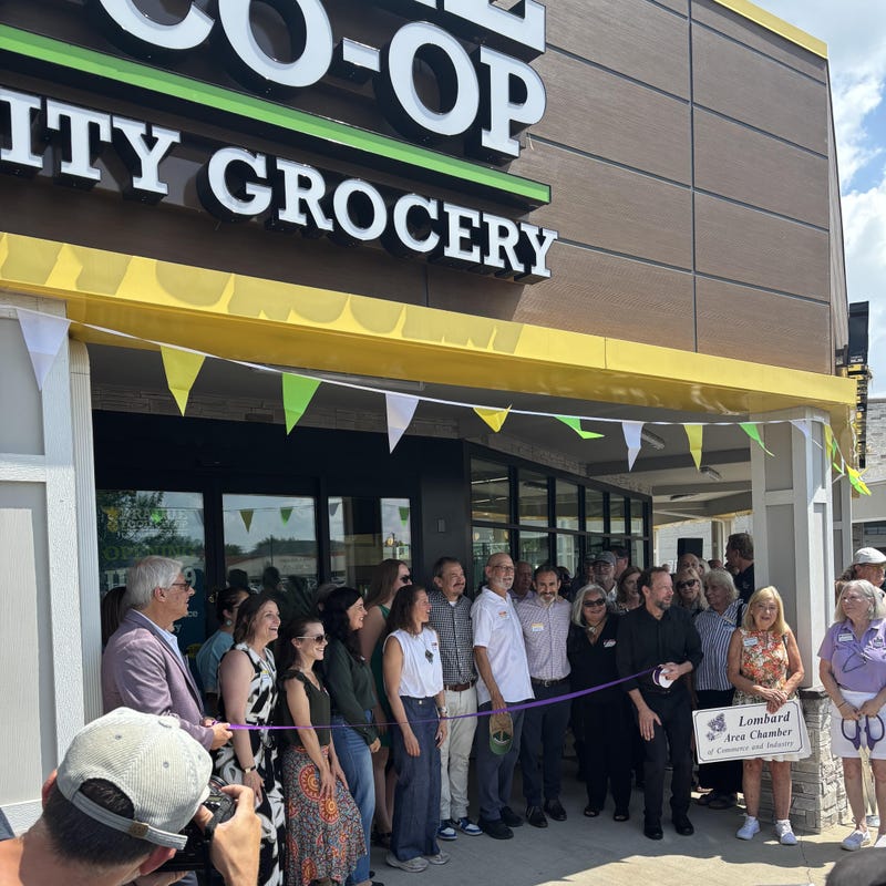 Founders cut the ribbon out front of Prairie Food Co-Op