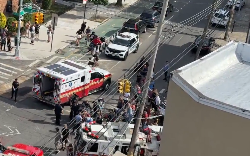 Officials respond to a scene in Astoria on Wednesday after a cyclist was struck by a vehicle fleeing police.