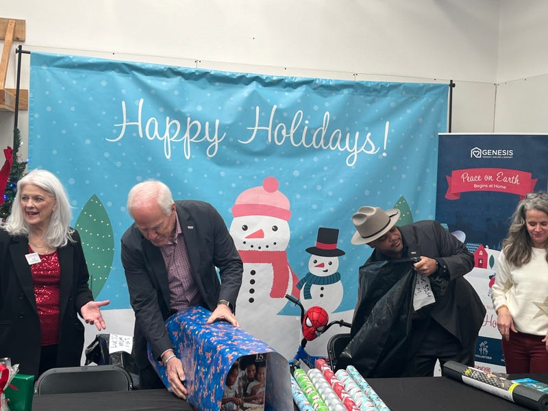 U.S. Sen. John Cornyn (R-TX) and Dallas Mayor Eric Johnson wrap gifts at a nonprofit in Dallas, Texas on Tuesday, Dec. 19, 2023.