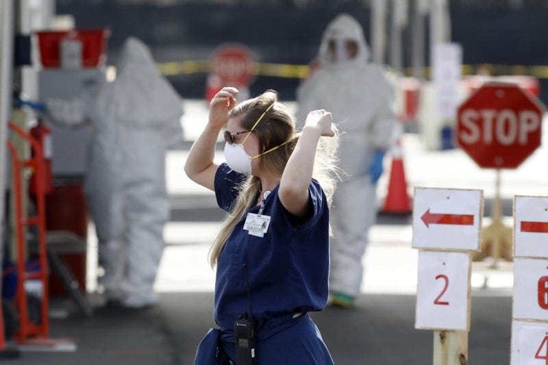 Medical University of South Carolina project manager Amy Jackson adjusts her face mask as healthcare providers dress in protective suiting