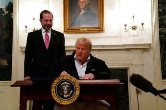 President Donald Trump signs an $8.3 billion bill to fight the coronavirus outbreak in the U.S., Friday, March 6, 2020 at the White House in Washington, as Department of Health and Human Services Secretary Alex Azar, looks on. (AP Photo/Evan Vucci)