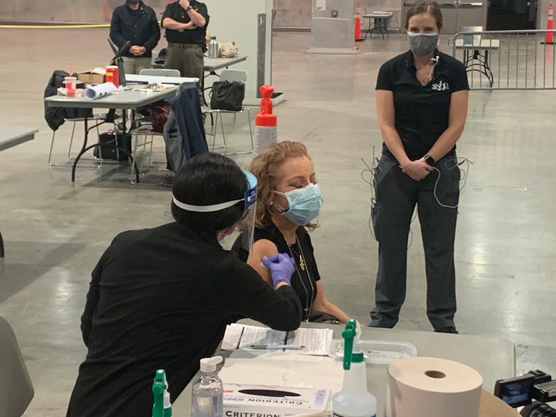 A woman receives a coronavirus vaccine