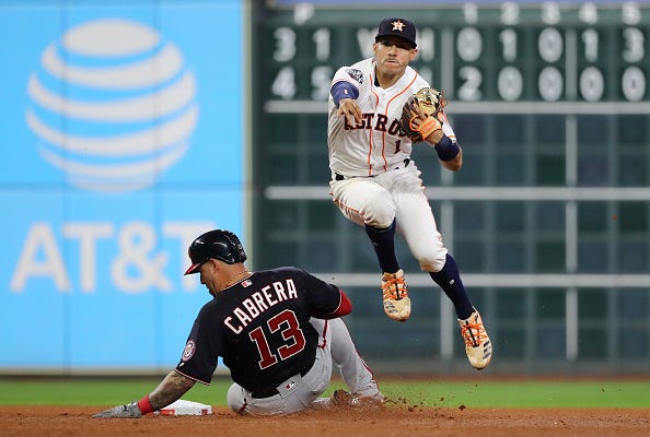 Carlos Correa evades Asdrubal Cabrera to turn two. 