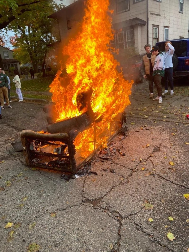 Couch set on fire by football fans in Michigan.