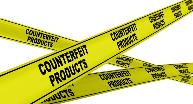Yellow warning tapes with black text COUNTERFEIT PRODUCTS