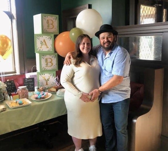 pregnant wife and husband at baby shower venue