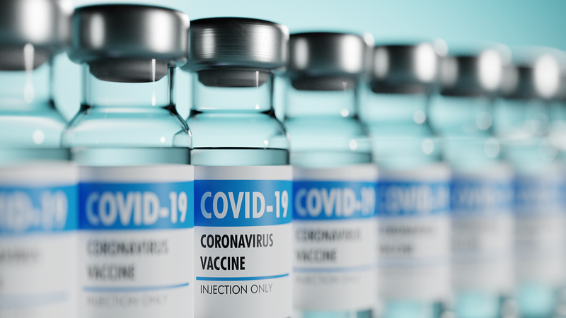 File photo of COVID-19 vaccine bottles lined up next to each other.