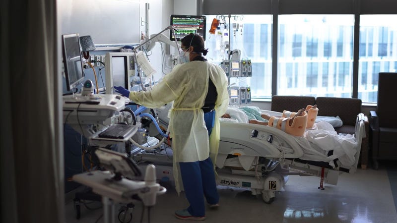 Respiratory Therapist Nirali Patel works with a COVID-19 patient in the ICU at Rush University Medial Center on January 31, 2022 in Chicago, Illinois.