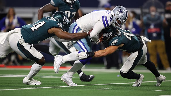Dak Prescott fights his way through Eagles defenders. 