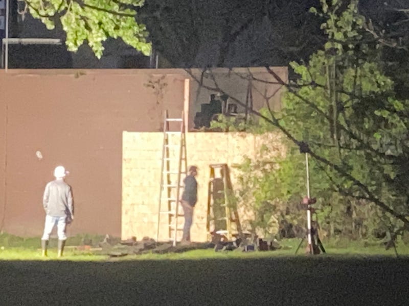 Workers board up a building after a car crashed into it in Southfield on Wednesday.
