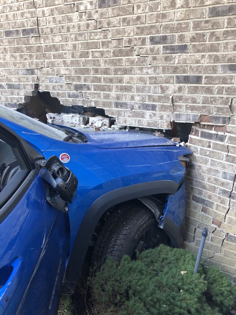 Jeep crashes into brick garage wall
