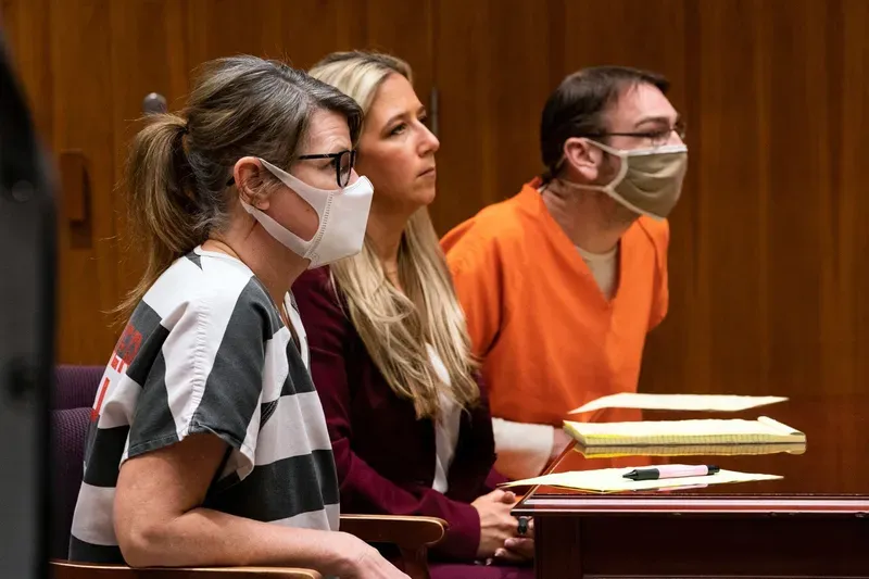 Jennifer Crumbley, sat to the left of attorney Muriel Lehman as her husband, James Crumbley