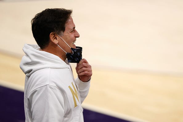 Mark Cuban pulls down his mask while watching Mavericks warm up.
